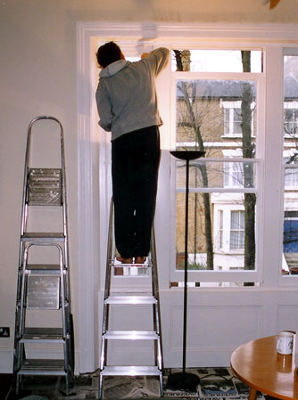 Morrie working on living room window